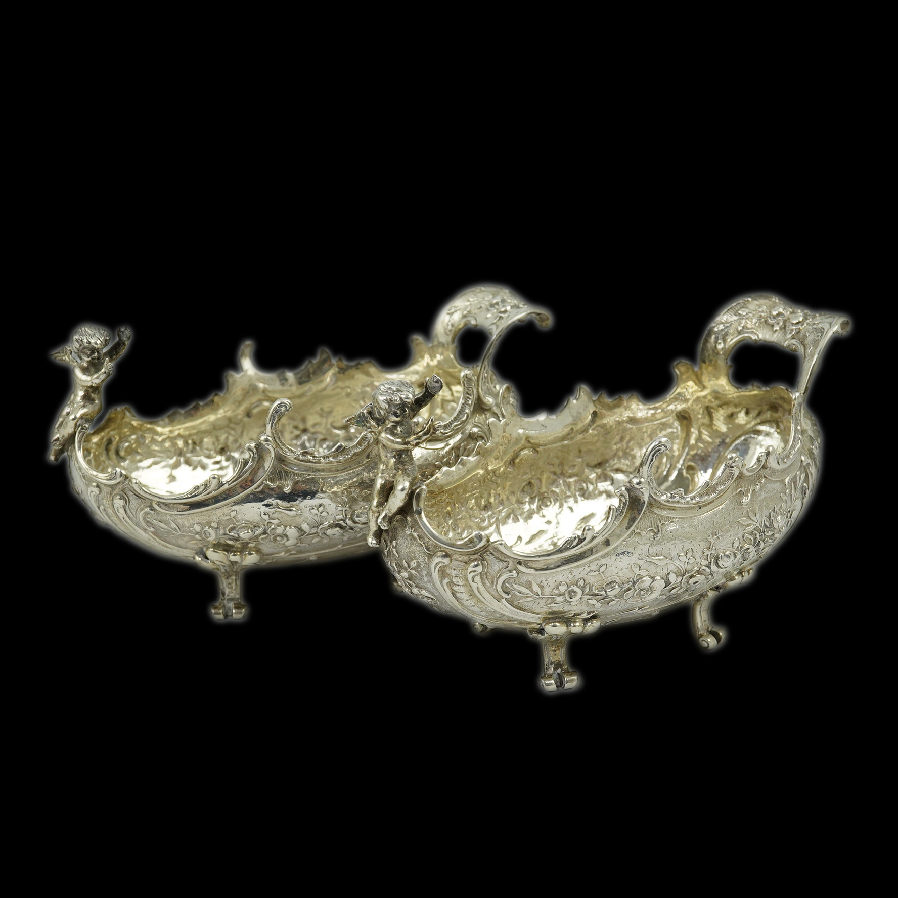 A pair of late 19th century German Hanau ornate embossed silver oval sweetmeat bowls